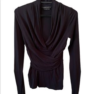Sexy black long sleeved top with draped detail at waist. BCBG in EUC size XS